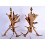 A PAIR OF EARLY 20TH CENTURY EUROPEAN CARVED ANTLER HORN LAMPS of naturalistic form. 48 cm x 20 cm.