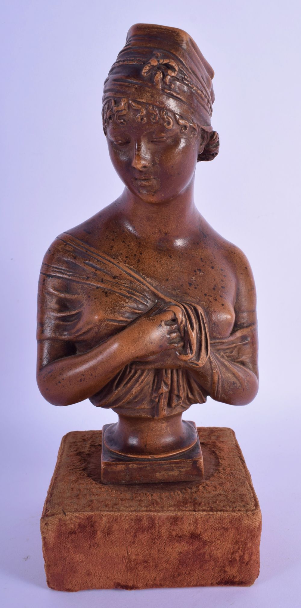 A 19TH CENTURY FRENCH PAINTED TERRACOTTA BUST OF A FEMALE After Houdon. 27 cm high.