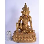 A LARGE CHINESE GILT BRONZE FIGURE OF A SEATED BUDDHA 20th Century, modelled upon a lotus capped bas