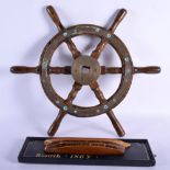 AN EARLY 20TH CENTURY MARITIME SHIPS WHEEL together with a painted half hull plaque. Largest 50 cm w