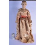A RARE EARLY 19TH CENTURY EUROPEAN PAINTED WOOD STANDING DOLL modelled in early Victorian silk robes