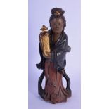 AN 18TH/19TH CENTURY CHINESE POLYCHROMED LACQUER FIGURE OF AN IMMORTAL modelled holding a temple vas