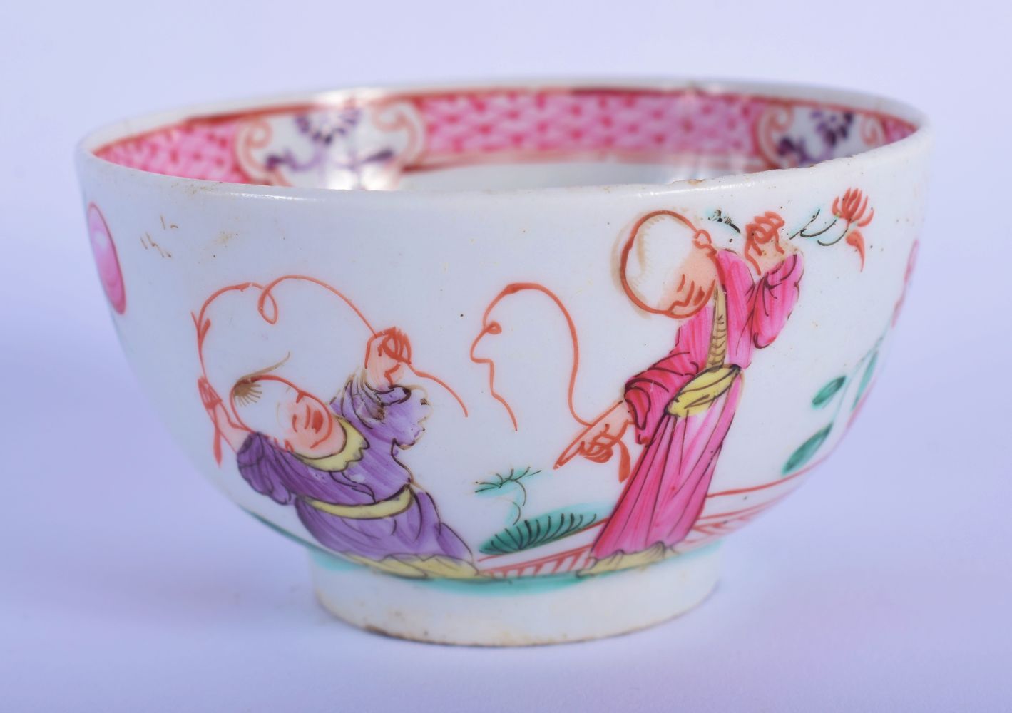 AN 18TH CENTURY ENGLISH PORCELAIN TEABOWL painted with figures in landscapes. 7.5 cm diameter.