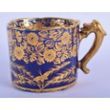 AN EARLY 19TH CENTURY ENGLISH PORCELAIN MUG gilded with flowers. 13 cm wide.