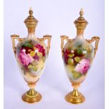 A PAIR OF ANTIQUE ROYAL WORCESTER VASES AND COVERS painted with roses. 22 cm high.