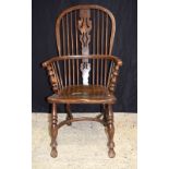 A 19th century wooden Windsor chair. 106 x 55cm