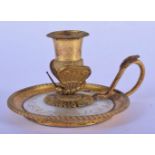 A 19TH CENTURY FRENCH PALAIS ROYALE GILT METAL CHAMBER STICK with serpent style handle. 11 cm x 8 cm