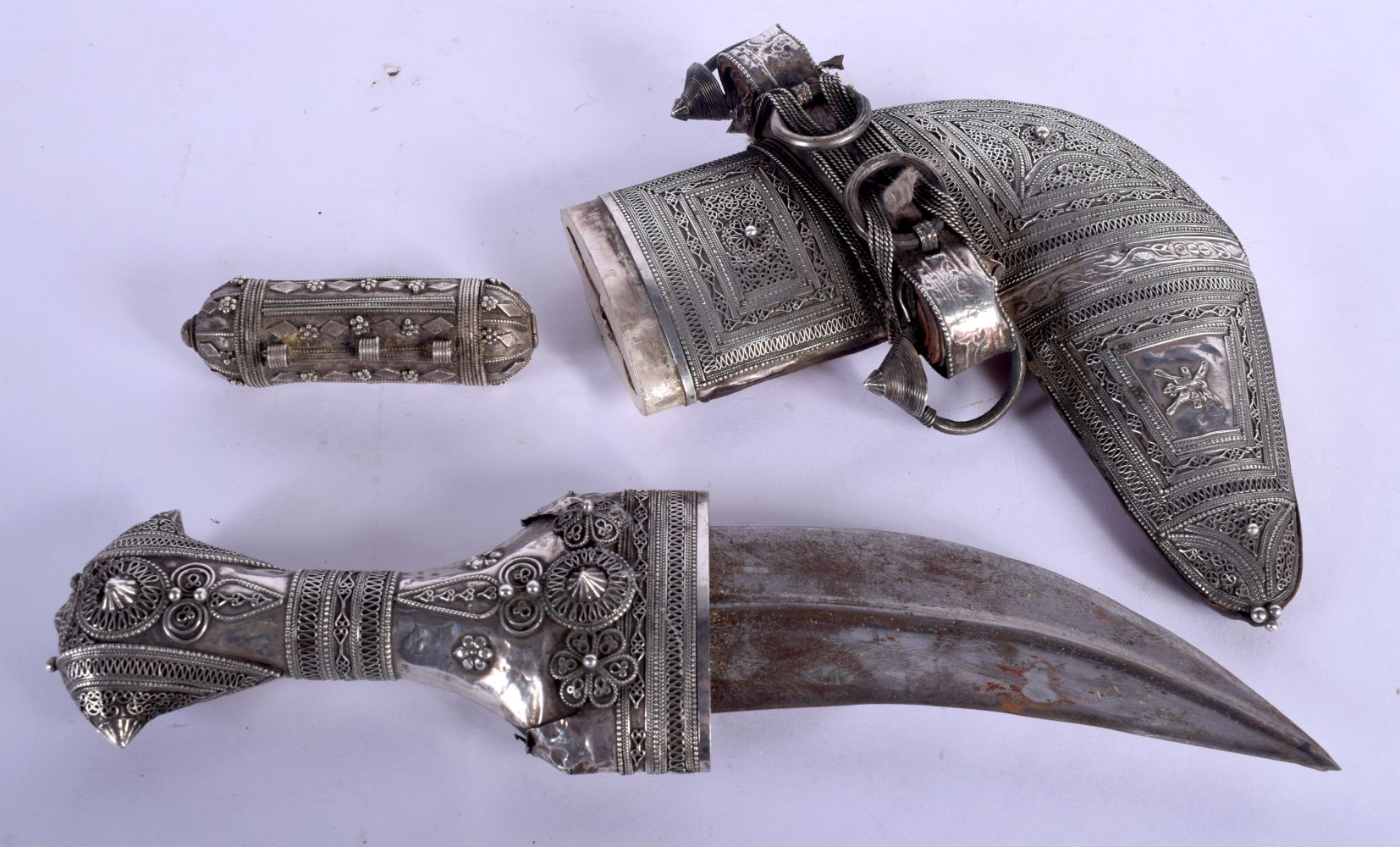 A 19TH CENTURY MIDDLE EASTERN OMANI JAMBIYA DAGGER overlaid with white metal. 36 cm long. 26 cm long