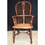 A 19th century wooden Windsor chair. 106 x 52cm