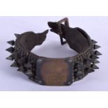 AN EARLY 19TH CENTURY BRUTALIST TYPE BRONZE STUD DOG COLLAR with brass plaque. 20 cm long approximat