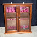 A small two shelf wooden glass fronted hanging display cabinet 70 x 67 x 24 cm.