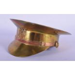 A 19TH CENTURY BRASS AND COPPER TRENCH ART MILITARY HAT. 13 cm wide.