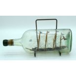 An antique ship in a bottle 30cm .