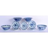 FOUR 18TH/19TH CENTURY CHINESE BLUE AND WHITE PORCELAIN BOWLS with similar smaller saucers. Largest