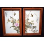 A pair of Chinese wooden framed porcelain panels decorated with birds, foliage and calligraphy. 32 x