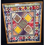 A large framed Middle Eastern textile 98 x 91cm.