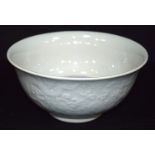 A Chinese porcelain Celadon bowl decorated in relief with dragons and lotus. 10 x 22cm