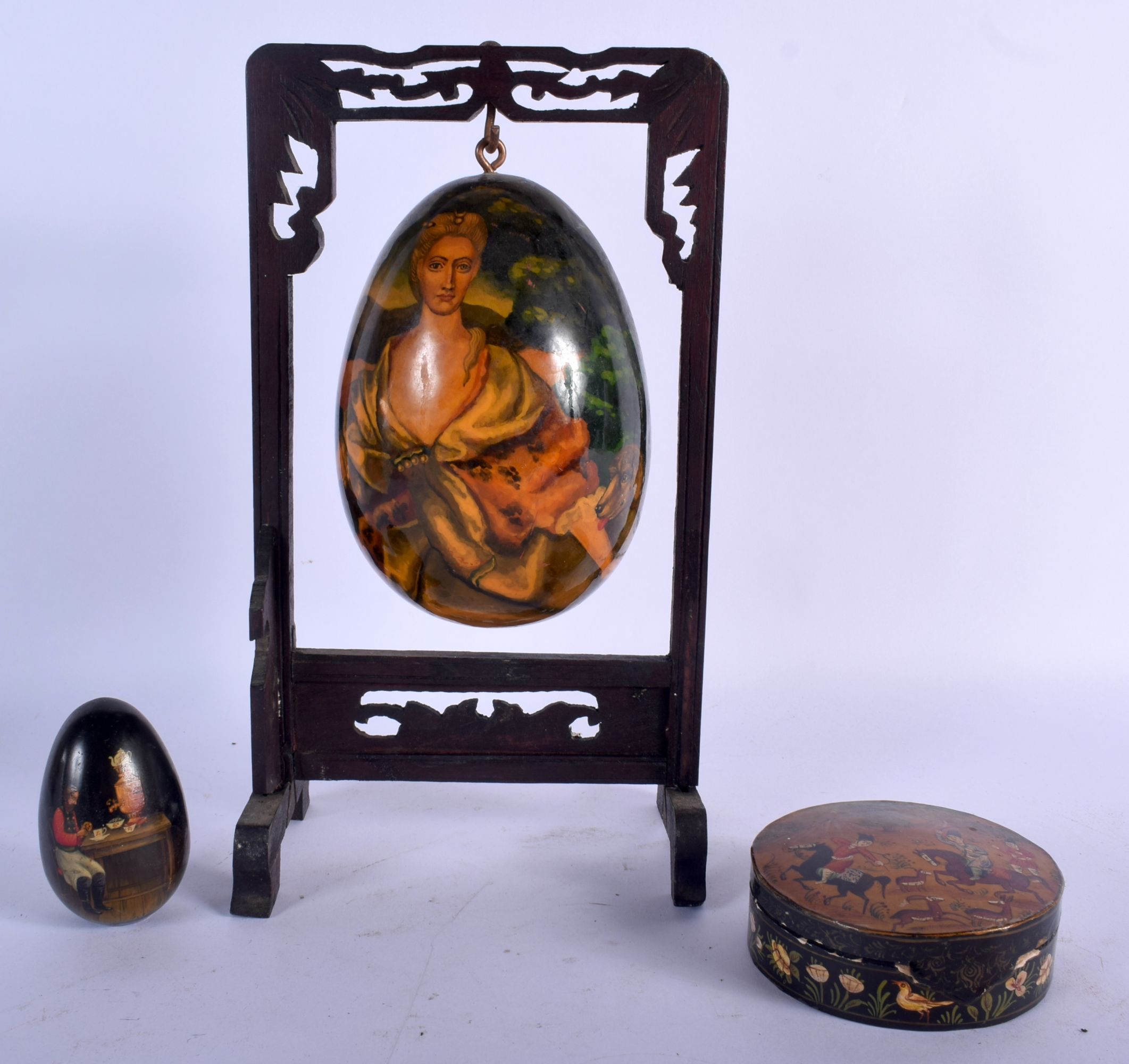 A RARE VINTAGE RUSSIAN EUROPEAN SUBJECT BLACK PAPIER MACHE EGG depicting a female and hound, togethe