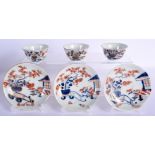 THREE 18TH CENTURY JAPANESE EDO PERIOD IMARI TEABOWLS AND SAUCERS painted with a building and landsc