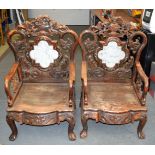 A PAIR OF 19TH CENTURY CHINESE CARVED HARDWOOD AND MARBLE CHAIRS decorated with mask heads. 105 cm x