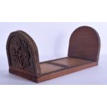 A 19TH CENTURY ANGLO INDIAN CARVED SANDALWOOD SLIDING BOOK RACK decorated with foliage. 60 cm x 20 c