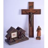 A VINTAGE BLACK FOREST MUSICAL CLOCK together with a Bavarian figure & a corpus christi. Largest 40