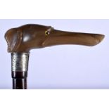 AN ANTIQUE CARVED RHINOCEROS HORN SILVER MOUNTED WALKING CANE with bamboo type shaft. 86 cm long.