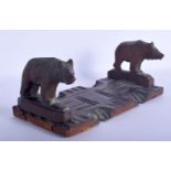 AN EARLY 20TH CENTURY BAVARIAN BLACK FOREST SLIDING BOOK RACK formed as standing bears. 44 cm x 12 c