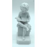 A small Parian ware figure of a child reading a book 20 cm.