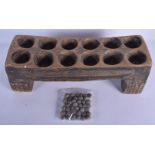 AN UNUSUAL VINTAGE TRIBAL CARVED WOOD MANCALA GAMING BOARD with carved nut counters. Board 50 cm x 1