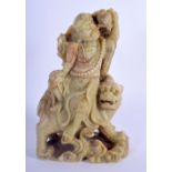 A 19TH CENTURY CHINESE CARVED SOAPSTONE FIGURE OF LUOHAN Late Qing, modelled sitting upon a buddhist
