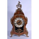 AN ANTIQUE FRENCH BRASS AND CARVED WOOD MANTEL CLOCK of rococo form, decorated with foliage. 55 cm x
