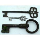 A large antique metal key together with two other keys 29cm (3)