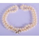 A PEARL NECKLACE WITH A DAMOND AND 14CT WHITE GOLD CLASP. Length 62cm, bead diameter 7.7mm, weight