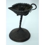 An Islamic heavily embossed metal candle holder 16cm