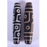 TWO TIBETAN DZI BEADS. 7cm long, 1.5cm wide (2)