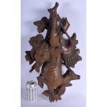 AN UNUSUAL 19TH CENTURY BAVARIAN BLACK FOREST CARVED WOOD HANGING LAMB decorated with flowers. 55 cm