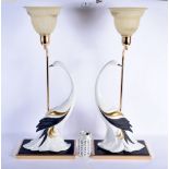 A PAIR OF 1960S PORCELAIN BIRD LAMPS upon a brass base. 57 cm x 22 cm.