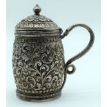 A small Repousse Indian silver tankard. 9cm