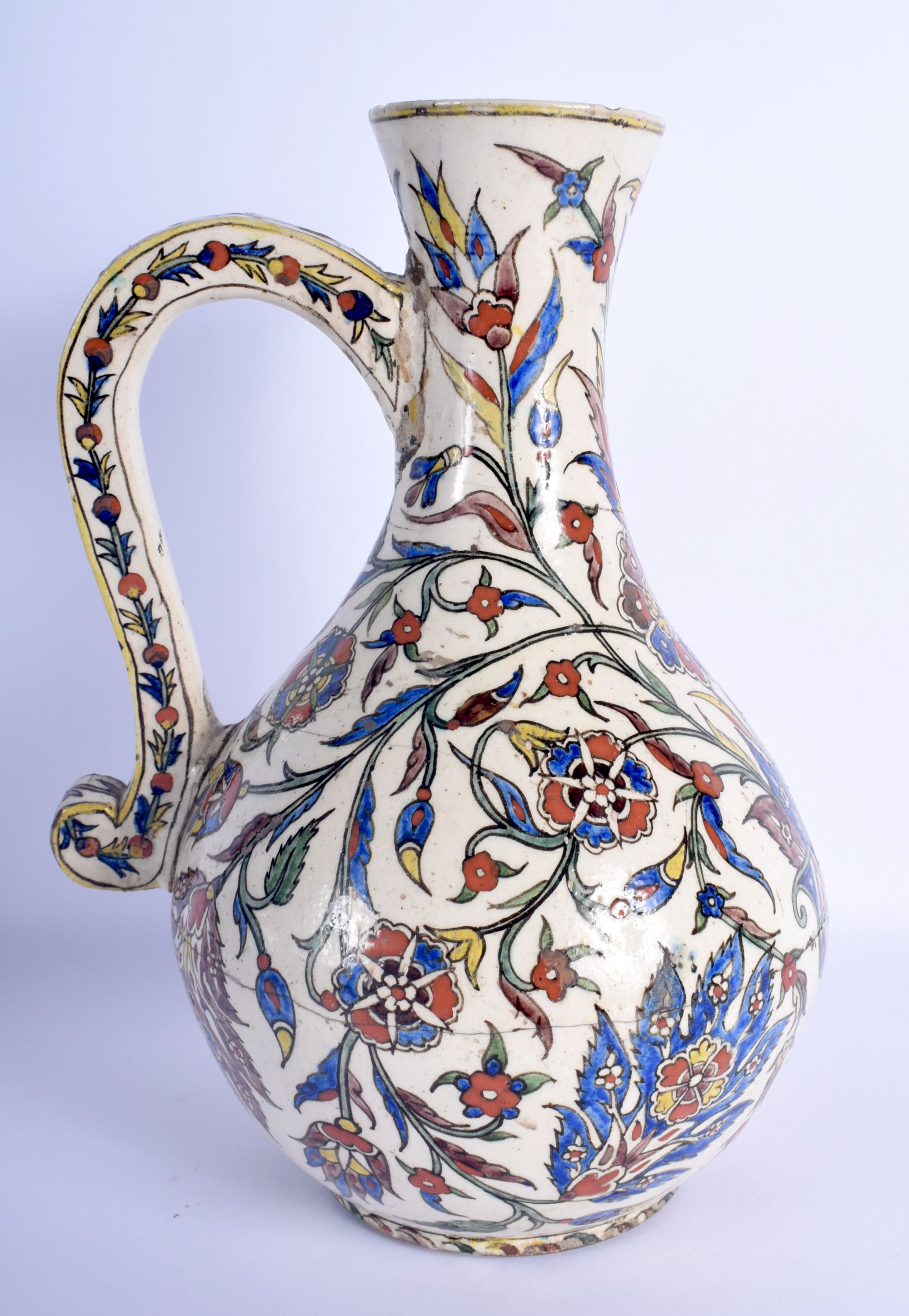 A 19TH CENTURY CONTINENTAL IZNIK FAIENCE GLAZED ENAMELLED JUG possibly Kutahya (Ottoman) painted wit