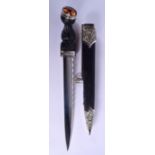 A SCOTTISH WHITE METAL MOUNTED CITRINE DIRK DAGGER with thistle overlaid leather scabbard. 44 cm lon