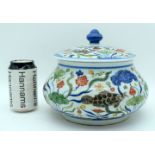 A Chinese porcelain Wucai jar and cover decorated with fish and algae. 19cm (2)
