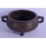 A LARGE CHINESE QING DYNASTY TWIN HANDLED BRONZE CENSER bearing Ming marks to base, decorated with A