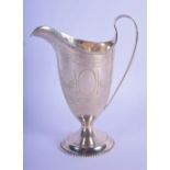 AN ANTIQUE SILVER HELMET FORM CREAM JUG engraved with motifs. Sheffield. 123 grams. 14 cm x 11 cm.