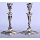 A PAIR OF 19TH CENTURY CONTINENTAL SILVER CANDLESTICKS of lozenge form. 701 grams overall. 19 cm x 1