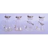 A SET OF FOUR ART DECO STYLE SILVER LIQUOR BOTTLES two with silver labels. Birmingham 1934, 1945 & 1