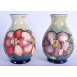 A PAIR OF MOORCROFT POTTERY VASES decorated with foliage. 16.5 cm high.