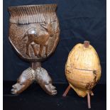 A large African wooden Tribal bowl carved with Antelope and African heads together with a coconut fa