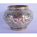 A 19TH CENTURY MIDDLE EASTERN ISLAMIC SILVER AND COPPER MIXED METAL CENSER decorated with script. 51