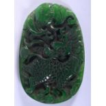 A CONTEMPORARY JADE PENDANT CARVED WITH A DRAGON. 9cm long, 6cm wide